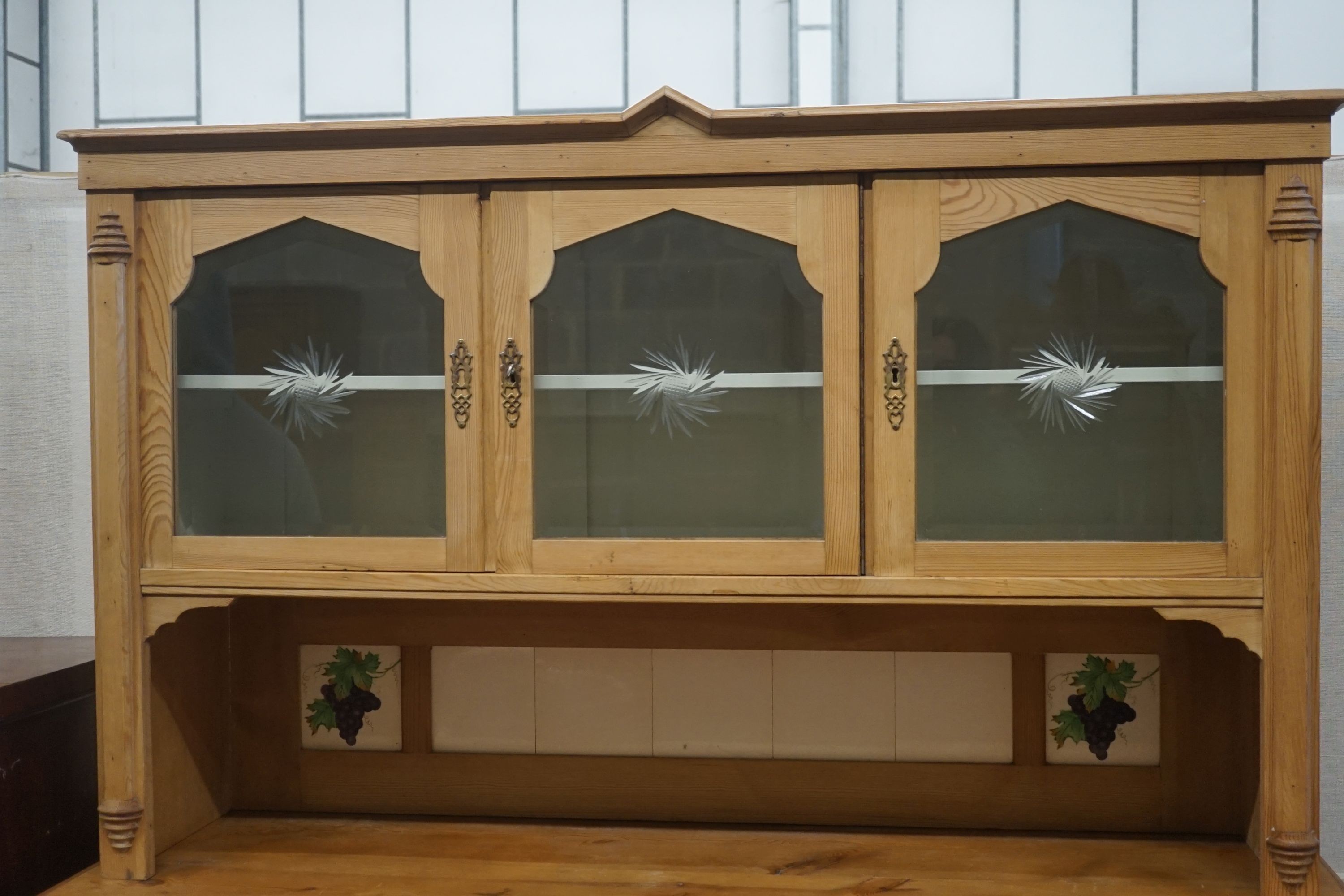 A 19th century Continental pine glazed side cabinet, width 142cm, depth 55cm, height 180cm